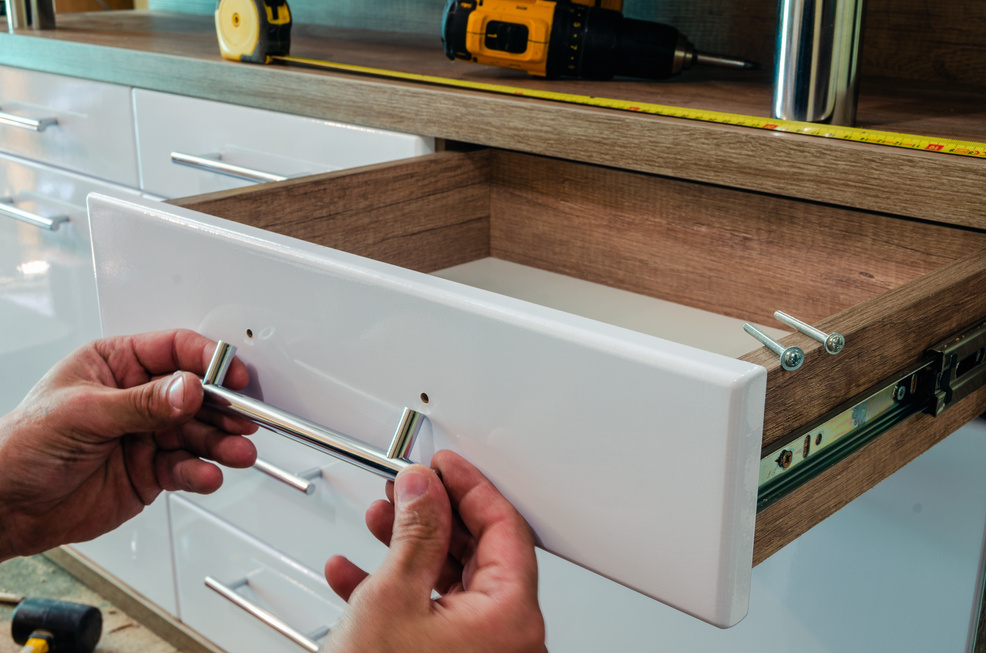 Assembling furniture, installing furniture decorative handles on the furniture facade