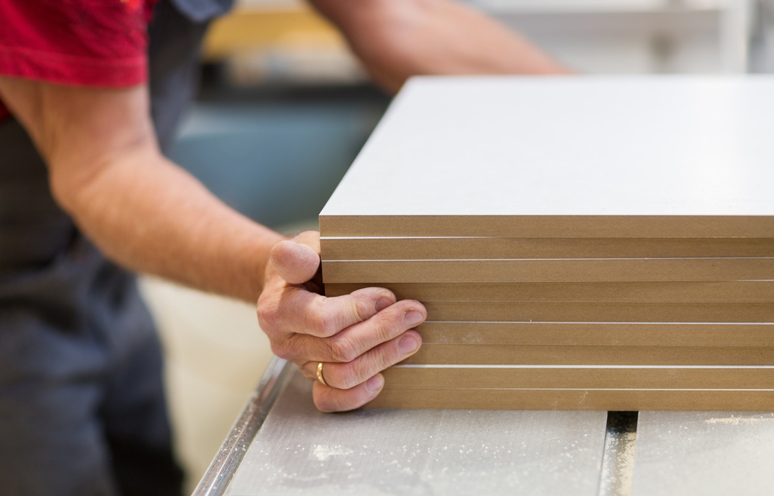 Close up of Carpenter with Boards at Factory