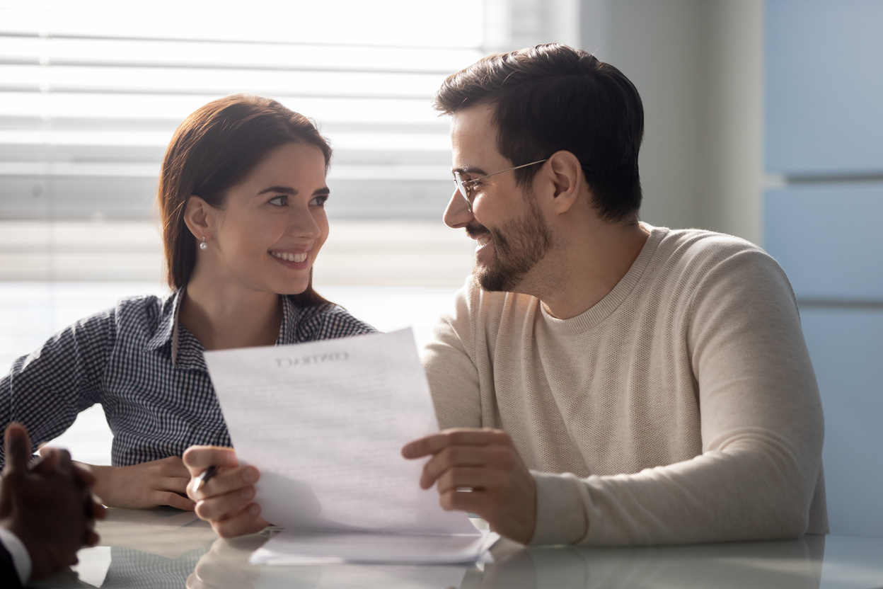 Couple read contract terms and conditions before signing mortgage contract